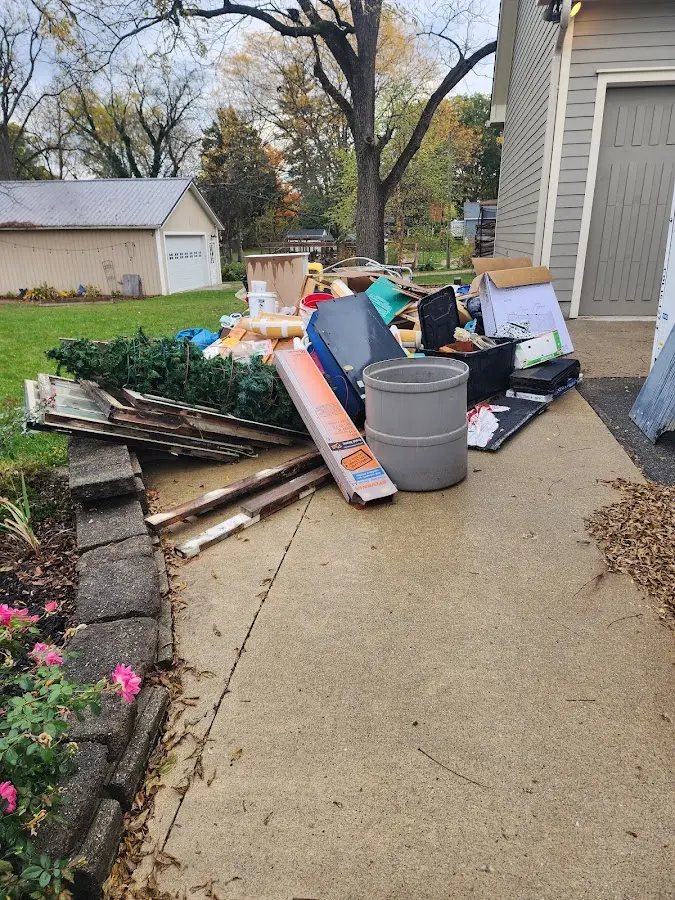 Dumpster being loaded with debris for Roofing Dumpster Rental in Des Moines